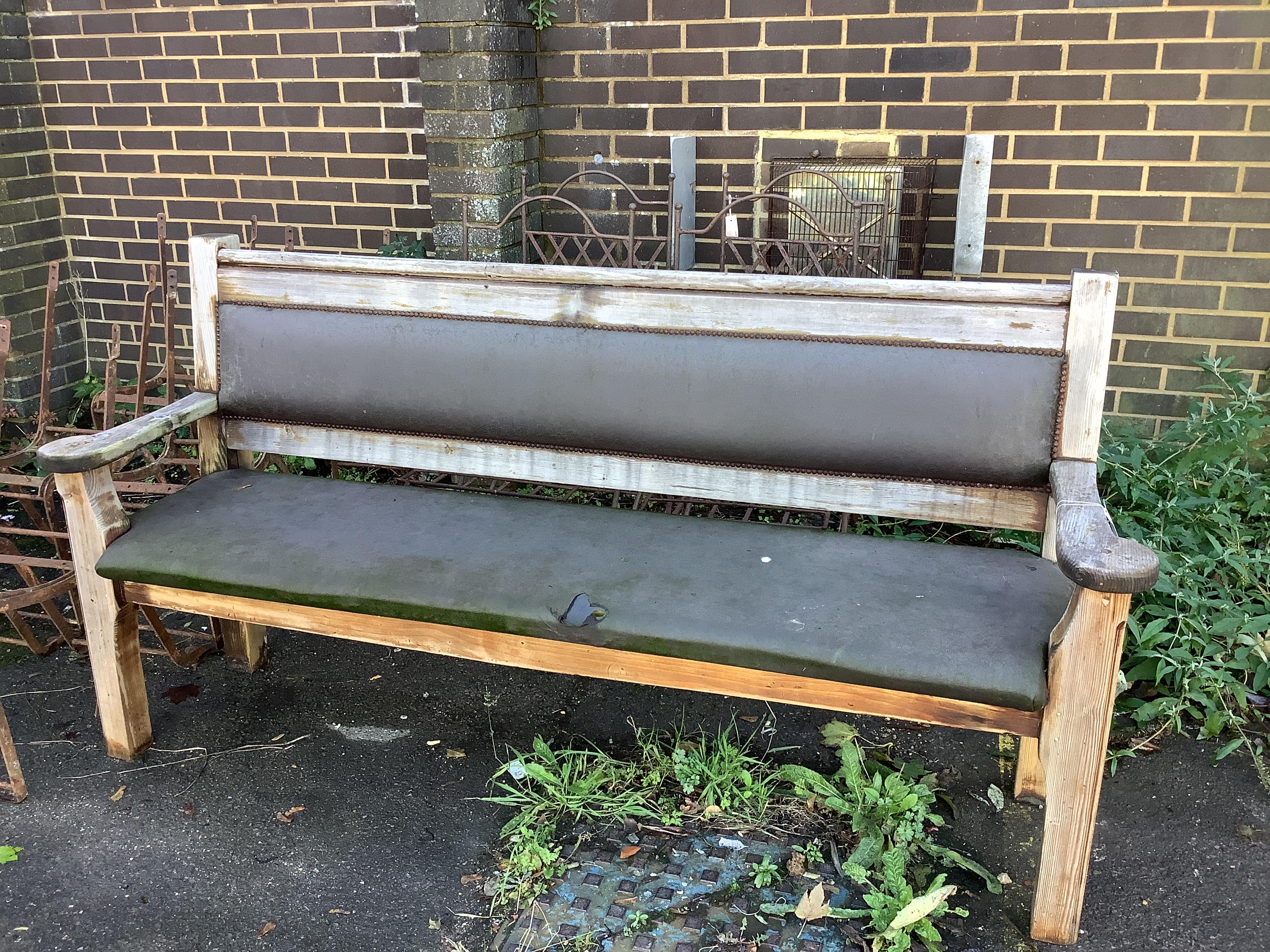 An upholstered pitch pine bench, width 197cm, depth 53cm, height 102cm